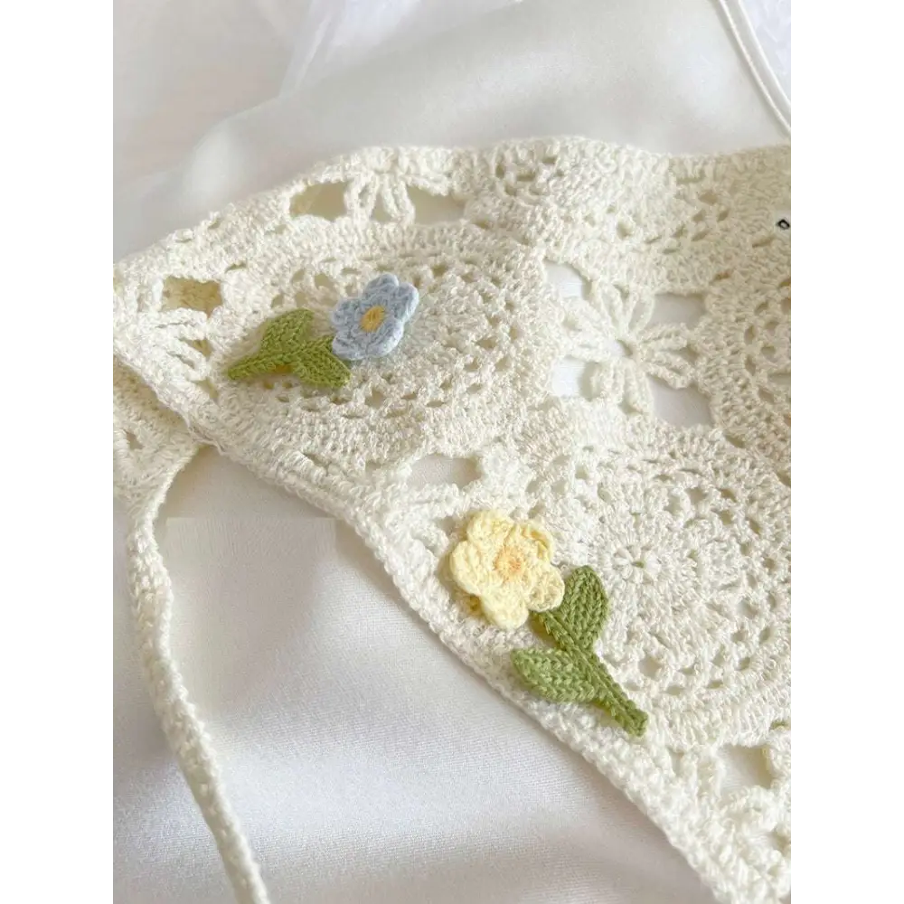 Delicate off-white crocheted french style triangular binder knitted headband with intricate lace and embroidered flowers