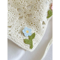 Delicate off-white crocheted french style triangular binder knitted headband with light blue flower and yellow center