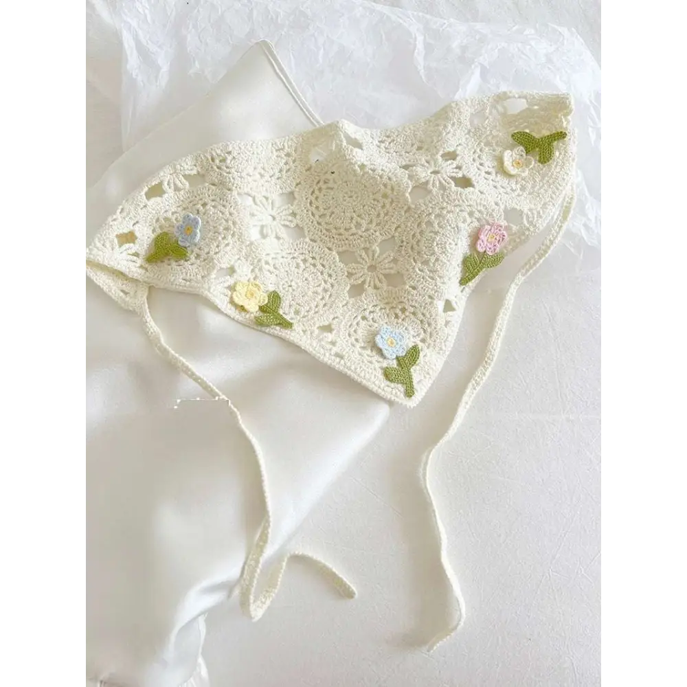 Off-white crocheted triangular binder knitted headband with delicate floral embroidery and soft textured knit finish