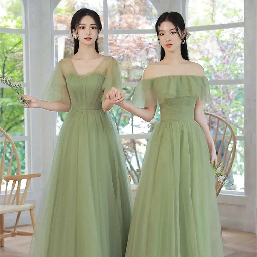 Two women wearing fruit green fashion personalized long tulle dresses with off-the-shoulder ruffled tops and sheer sleeves