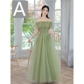 A flowing fruit green fashion personalized long tulle dress with an off-the-shoulder ruffled bodice and layered skirt