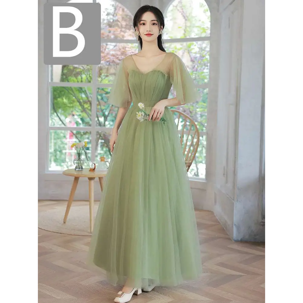 A flowing fruit green fashion personalized long tulle dress with sheer puff sleeves and floral embroidery at the waist