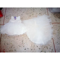 A delicate white tulle flower girl tuxedo with fitted bodice and layered ruffles in the fuchsia layered ruffled style