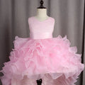 A delicate pink fuchsia layered ruffled flower girl tuxedo dress with lace bodice and trailing tulle skirt