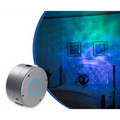 Silver cylindrical galaxy starry sky projector with rotating feature and blue illuminated ring on front face