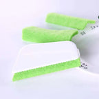 Bright green rectangular gap brush with white plastic handle and textured sponge scrubber for cleaning window grooves