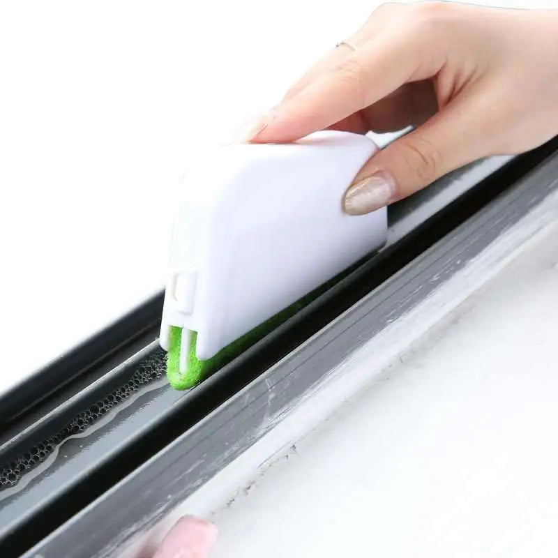 White plastic gap brush with green bristles sponge scrubber designed for cleaning window grooves and tracks