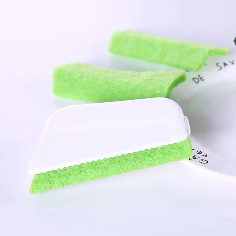 Bright green rectangular gap brush with white handle and textured sponge scrubber for cleaning window grooves