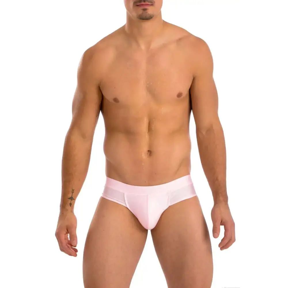 A sleek light pink gary majdell sport mens cheeky brief swimsuit with smooth fabric and subtle side seams