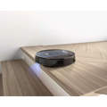 Black circular robot vacuum cleaner with glossy finish and subtle branding featuring strong suction by Geek Smart Robot