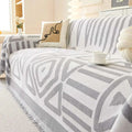 Geometric black and white chenille sofa cover with gray and white woven pattern and fringed edges for sofa protection