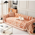 Orange and cream geometric-patterned chenille sofa cover with fringed edges for a white chenille sofa design