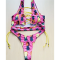 A vibrant pink geometric halter swimwear thong bikini with pineapple print yellow lacing and matching ties for big boob women