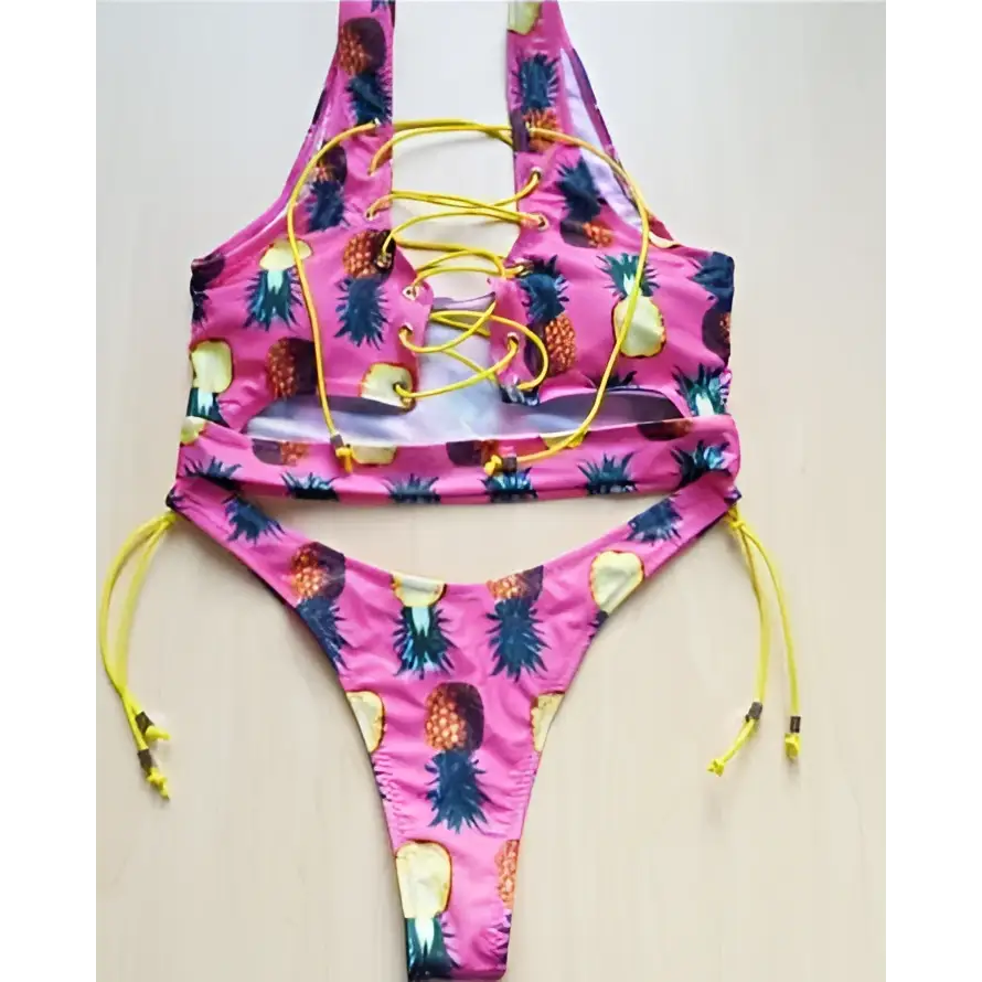 A vibrant pink geometric halter swimwear thong bikini with pineapple print yellow lacing and matching ties for big boob women