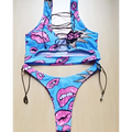 A vibrant blue geometric halter swimwear thong bikini with pink lips pattern and adjustable black drawstrings for big boob women