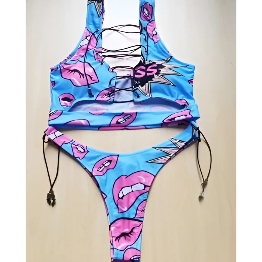A vibrant blue geometric halter swimwear thong bikini with pink lips pattern and adjustable black drawstrings for big boob women