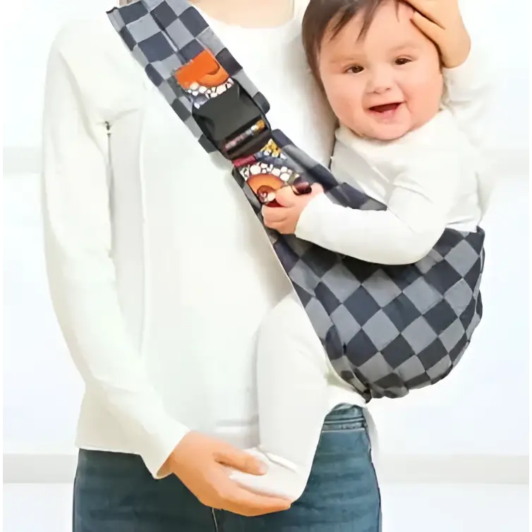 Geometric patterned black and white baby sling carrier with a black and gray checkered design and colorful cartoon strap prints