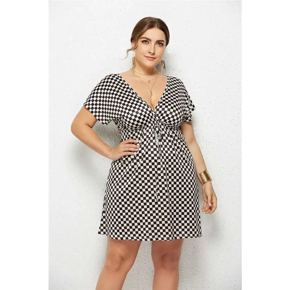 Black and white geometric printed deep v-neck short-sleeved dress with tied waist and elastic detailing