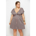 A plus-size woman wears a geometric printed deep v-neck elastic waist dress in red green and white pattern