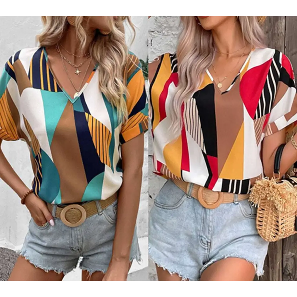 A vibrant geometric-patterned women’s printed v-neck top with bold red black yellow and white abstract shapes