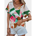 A vibrant geometric-patterned women’s clothing printed v-neck top in shades of green pink brown and white
