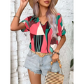 A vibrant geometric-patterned women’s short-sleeve top in pink green black and white with a v-neckline for casual wear