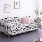Geometric woven fringed sofa blanket in gray with black and rust accents featuring fringe detailing for sofa use