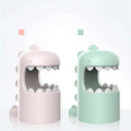 Pastel pink and mint green george dinosaur mosquito lamp with smooth plastic bodies and open mouths as mosquito storage box