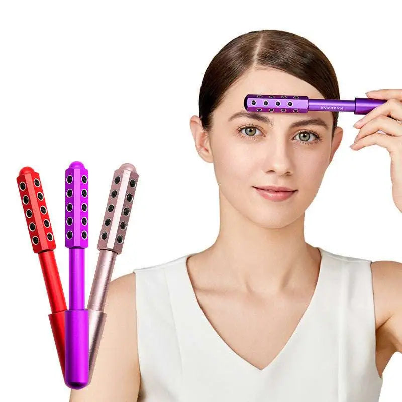 Purple red and rose gold germanium beauty roller massage sticks with black circular indentations for facial massage use