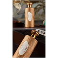 Golden wood grain bottle with metallic cap and oval white label in gilded liquor gift box set