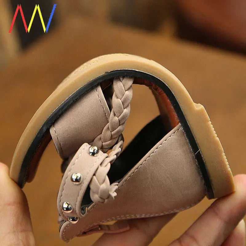 Girls braided beige sandals featuring silver studs, braided leather straps, and a tan rubber sole for comfortable wear