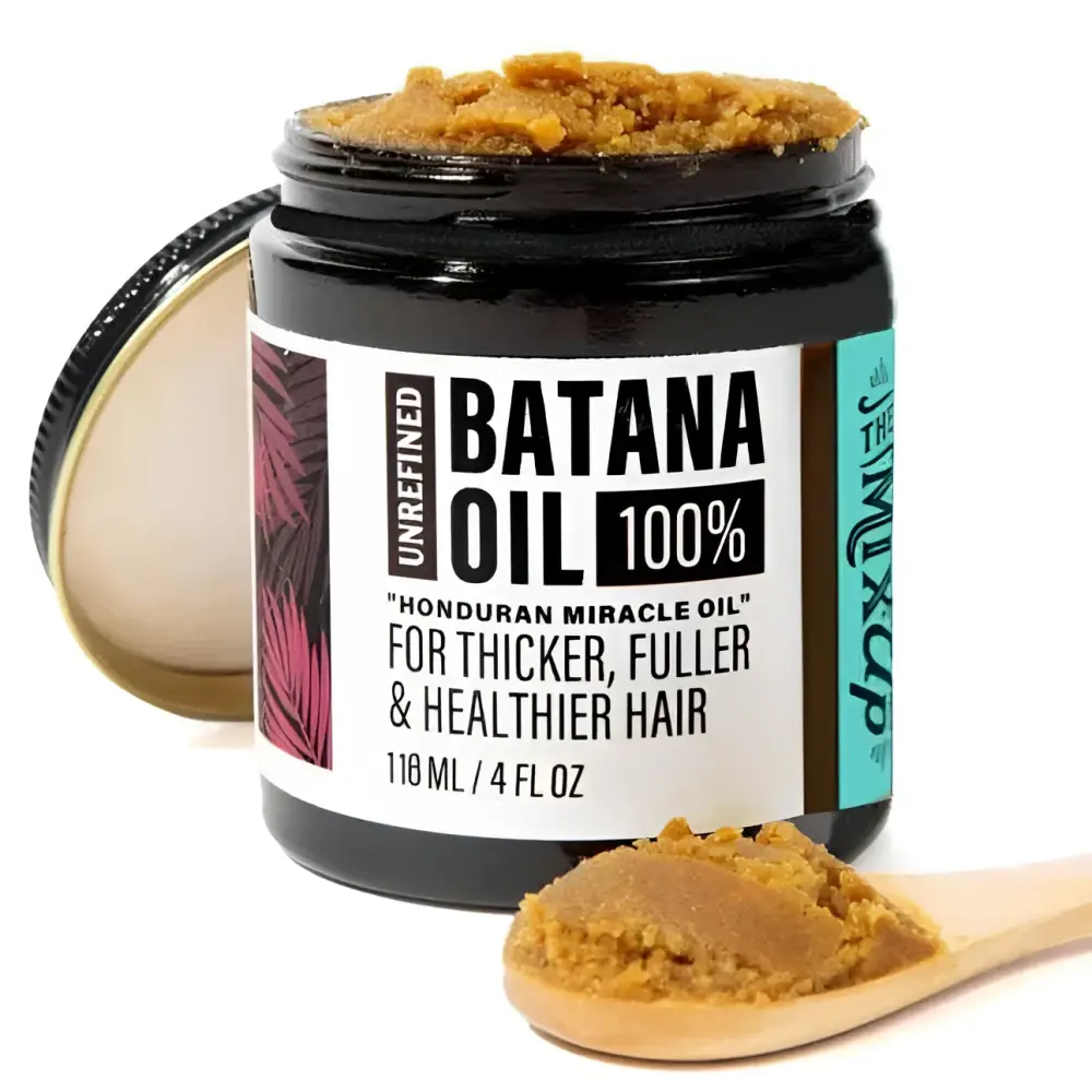 A black glass jar of golden-brown unrefined batana oil in glow restore hair mask for deep restore hair treatment