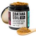 A black glass jar of golden-brown unrefined batana oil in glow restore hair mask for deep restore hair treatment