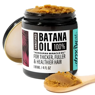 A black glass jar of golden-brown unrefined batana oil in glow restore hair mask for deep restore hair treatment
