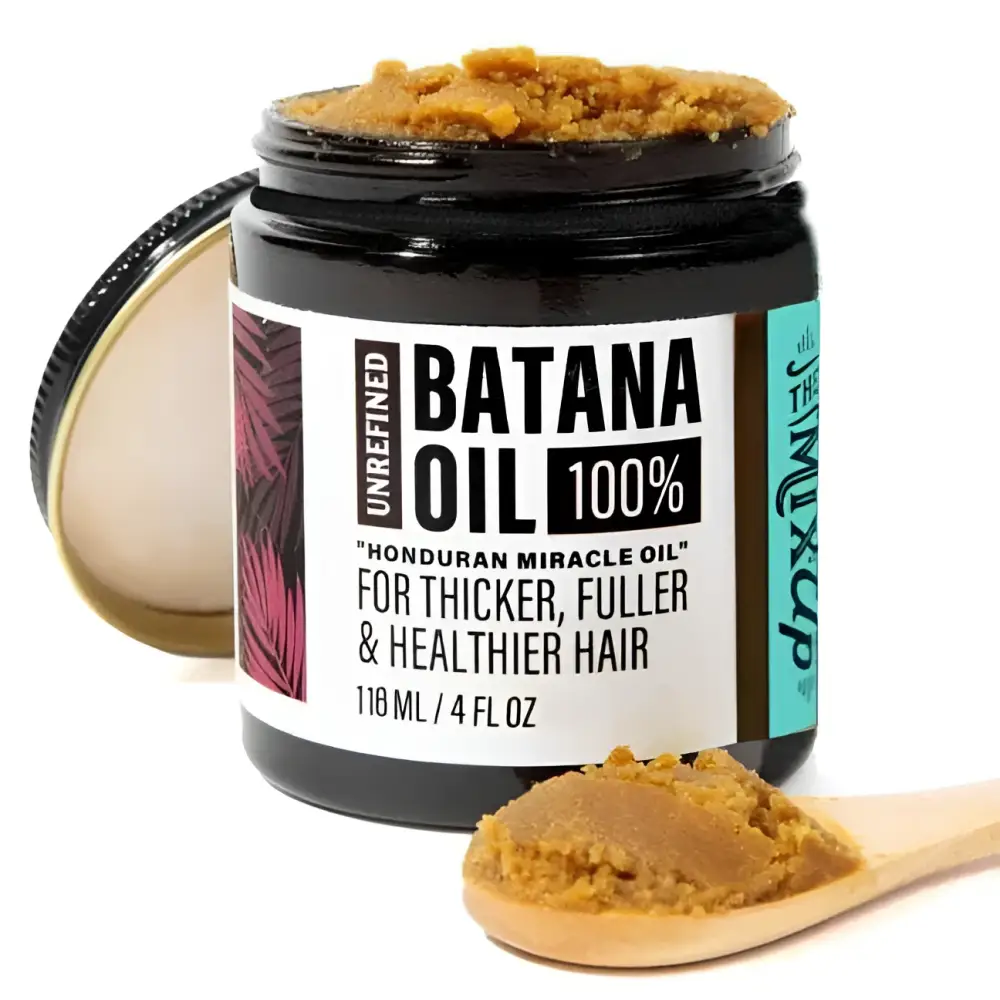A black glass jar of golden-brown unrefined batana oil in glow restore hair mask for deep restore hair treatment