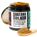 Glow restore hair mask batana oil treatment in a black jar with golden brown unrefined batana oil on spoons