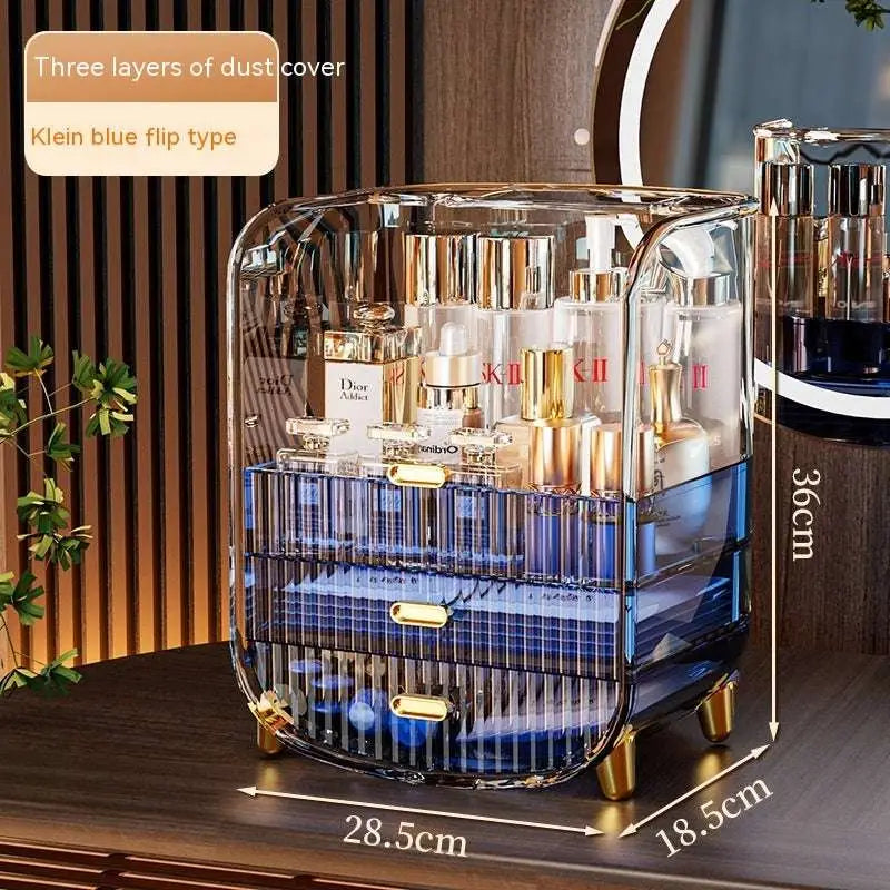 Transparent blue acrylic cosmetics storage box with gold tone hardware and three tiered flip top makeup organizer design