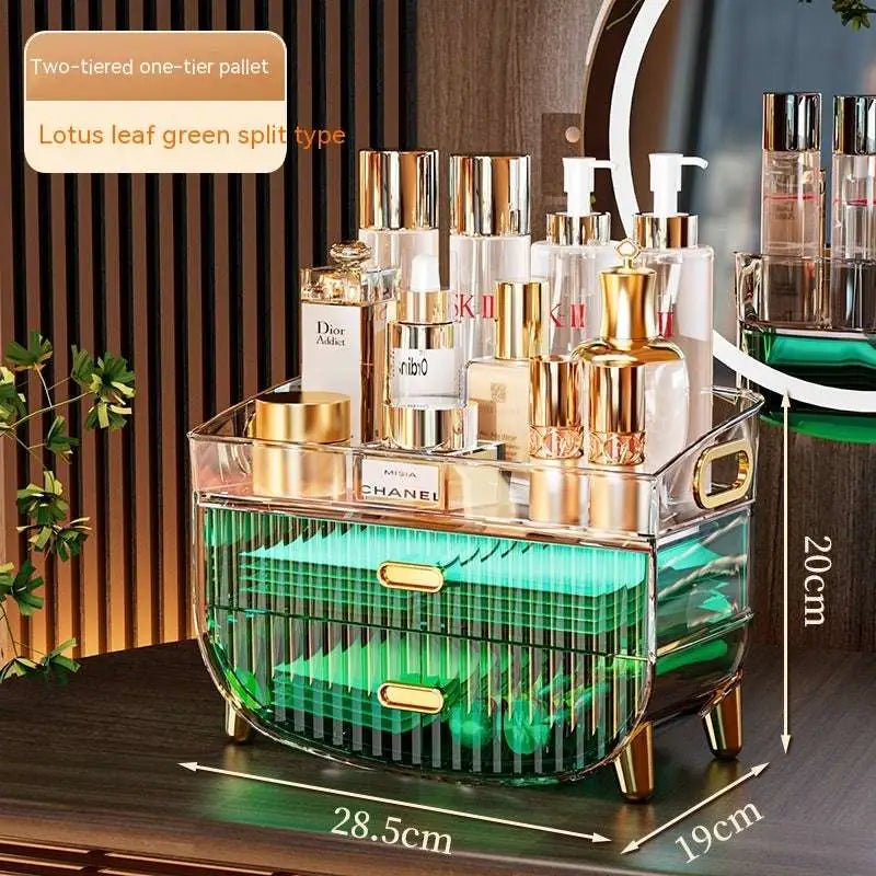 Transparent acrylic cosmetics storage box with gold-tone handles and legs, green illuminated interior, and two drawers