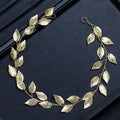 Gold and silver leaf hair band featuring a golden leafy headpiece with intricate filigree and delicate wire branches