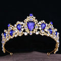 A gold baroque rhinestone crystal bridal crown featuring deep blue teardrop crystals and clear rhinestones in a floral design