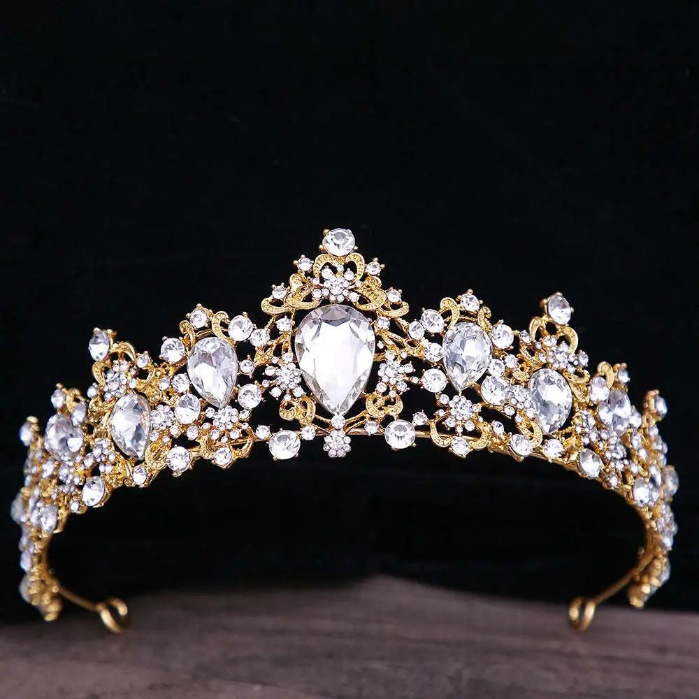 A sparkling gold baroque rhinestone crystal bridal crown with intricate filigree and pear-shaped teardrop crystals