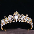 A sparkling gold baroque rhinestone crystal bridal crown featuring intricate filigree and pear-shaped teardrop crystals
