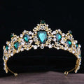 A gold baroque rhinestone crystal bridal crown with emerald green and clear crystal jewels in an intricate floral design