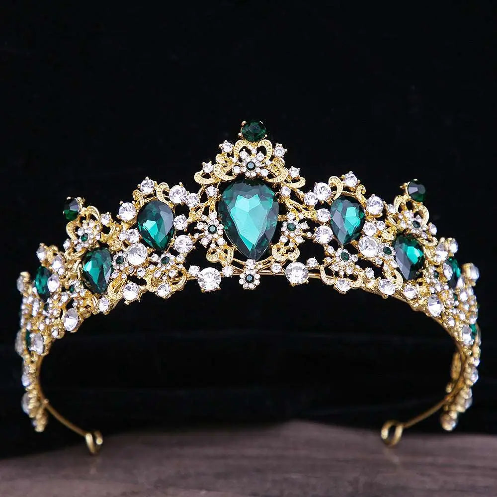 A gold baroque rhinestone crystal bridal crown with emerald green and clear crystal jewels in an intricate floral design