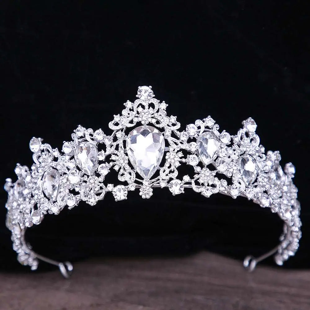 A sparkling silver crystal bridal crown with intricate filigree and large pear-shaped baroque rhinestone crystals