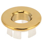 Gold bathroom wash basin sink hole overflow cover with polished metal finish and white plastic flanges flush mount fixture