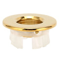 Gold bathroom wash basin sink hole overflow cover with circular gold fixture and white plastic flush mount base
