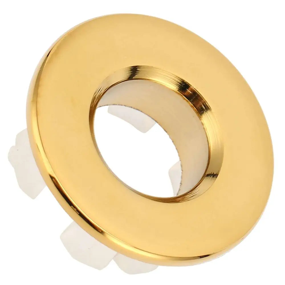 Gold bathroom wash basin sink hole overflow cover with gold circular recessed light fixture and white mounting clips