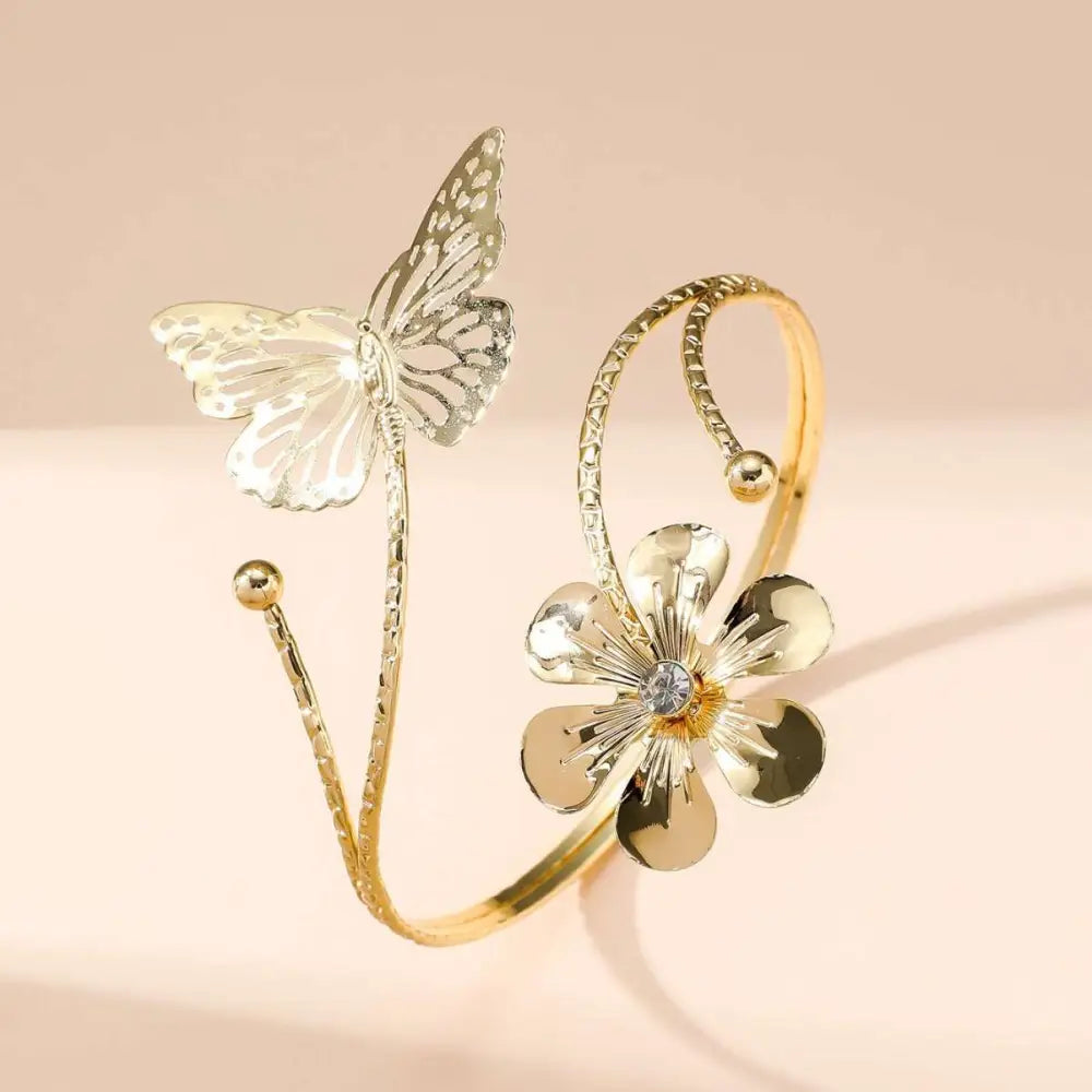 Gold butterfly arm cuff with intricate cut-out gold-toned butterfly wing and central crystal accent fashion accessory