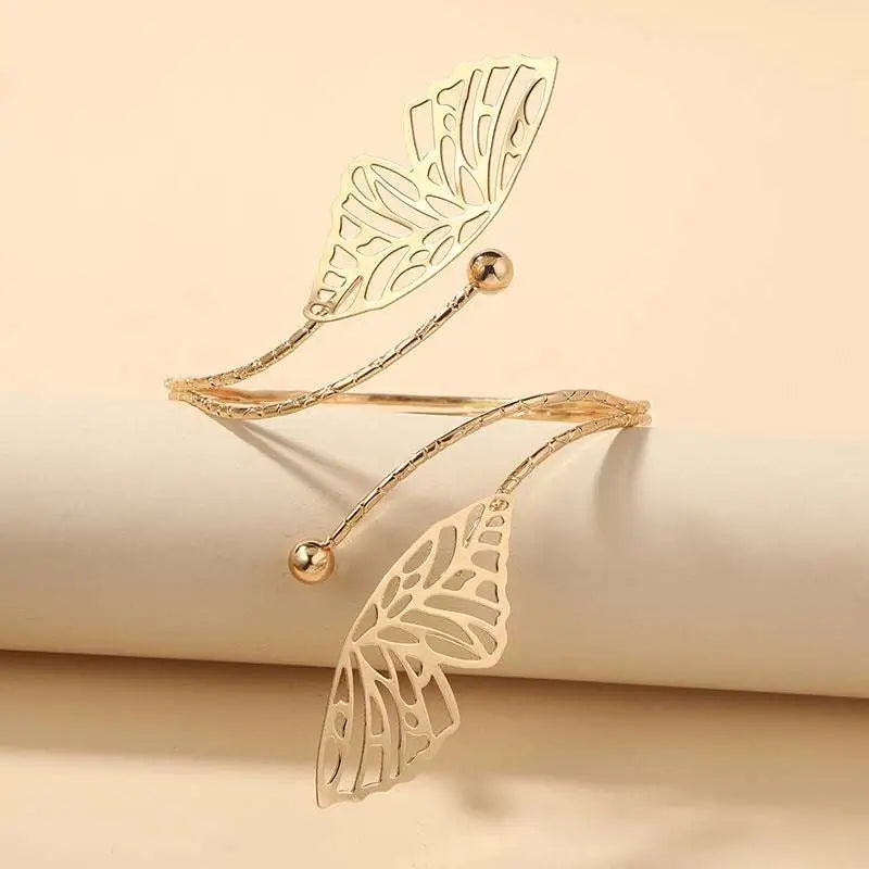 Gold-toned butterfly arm cuff featuring intricate cut-out butterfly wings and small spherical accents for fashion personality